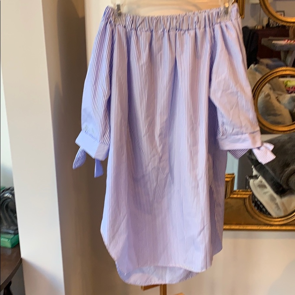 Off-the-shoulder blue-striped top.